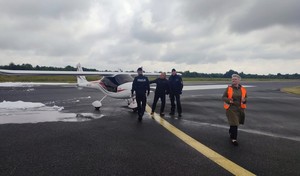 Policjanci na płycie lotniska przy samolocie, który został wykorzystany na potrzeby organizacji ćwiczeń