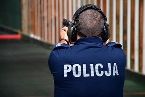 policjant podczas strzelania w czasie turniejowych zmagań