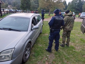 zagraniczni grzybiarze na polu namiotowym podczas kontroli służb